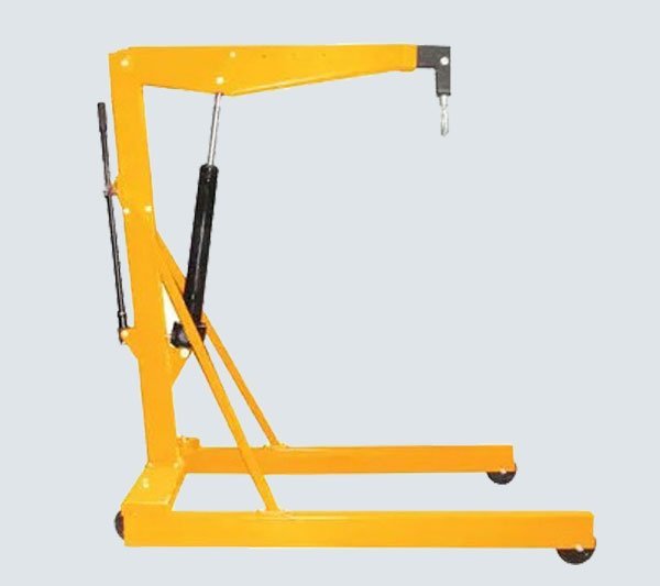 Manual mobile floor crane with hydraulic jib lifting a load