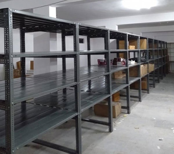 Section panel rack storing sheet and panel stock in an industrial warehouse